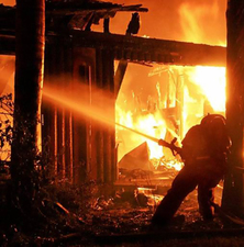 Firefighter at engulfed house